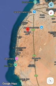 a map of a desert with a red dot at Maison mazar in Bin Fatāʼil