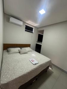 a bedroom with a bed with a scale on it at D Castro Executive in Montes Claros
