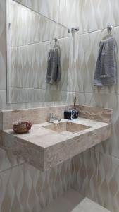 a bathroom with a sink and a mirror at Suítes Rufino in Lençóis