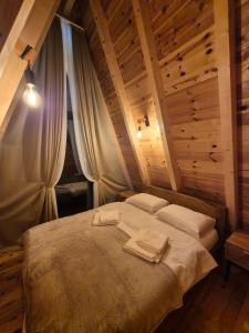 a bedroom with a large bed in a wooden ceiling at Villa Evergreen Žabljak in Žabljak