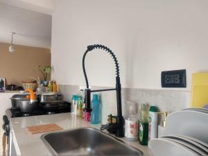 a kitchen sink with a faucet in a kitchen at Casa Las Pencas in Maimará