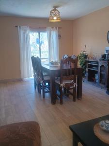 a living room with a dining room table and chairs at Casa Las Pencas in Maimará +3 photos