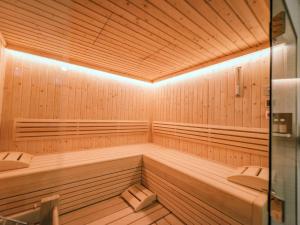 a wooden sauna with two benches and a light at Green Garden Lodge B1 in Piesendorf +32 photos