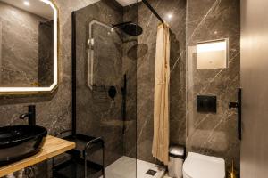 a bathroom with a shower with a toilet and a sink at GLP Sivota in Syvota