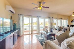 a living room with a couch and a flat screen tv at Villa 12 at Mara Laguna - Gold Standard Certified in San Pedro
