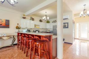 a kitchen with a island with bar stools at Villa 12 at Mara Laguna - Gold Standard Certified in San Pedro