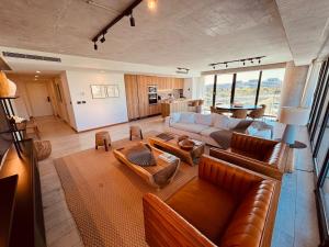 a living room with a couch and a table at Surfside - 3 Suítes - 4 Bathroom in Punta del Este
