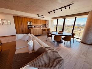 a living room with a couch and a table at Surfside - 3 Suítes - 4 Bathroom in Punta del Este +85 photos