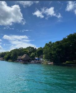 a view of a resort from a boat in the water at Navega en velero privado Motoko en la laguna de los 7 colores en Bacalar Quintana Roo in Bacalar