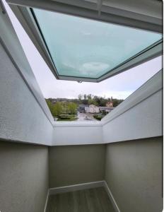 a skylight in a room with a ceiling at Studio Havane avec clim in Bourbonne-les-Bains +2 photos