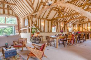 a dining room with tables and chairs in a barn at 6 Bed in Ardleigh oc-b35089 in Ardleigh