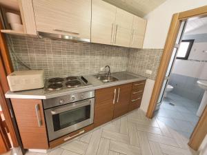 a kitchen with a stove and a sink at Sunrise Dhermi Beach in Dhërmi