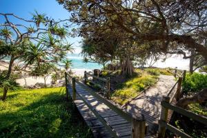 a wooden path to the beach with a wooden fence at Breakwater Views Apartment 2 Cabarita Beach in Cabarita Beach