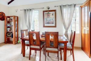a dining room with a wooden table and chairs at The Pine Tree Villa in San Ignacio