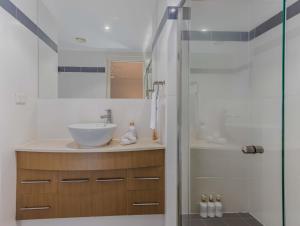 a bathroom with a sink and a shower at Breakwater Views Apartment 2 Cabarita Beach in Cabarita Beach