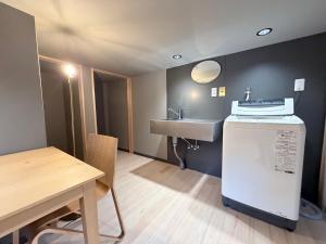 a small room with a sink and a table at KUMANOYASAI Cottage in Chikatsuyu in Tanabe