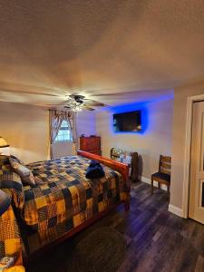 a bedroom with a bed and a blue light at Rowan's Mountain View in Powell