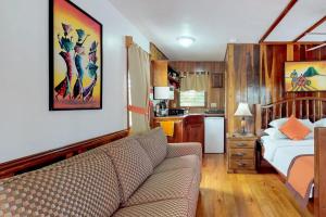 a living room with a couch and a bed and a kitchen at Latitude Adjustment Gold Standard Certified in Hopkins