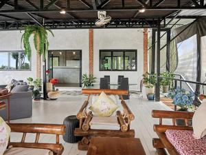 a living room with wooden benches and a couch at Para Hill Homestay in Ban Muang Mai