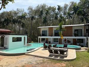 a house with a swimming pool in front of it at Para Hill Homestay in Ban Muang Mai +53 photos