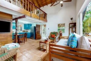a living room with a couch and a tv at Ocean Edge Gold Standard Certified in Maya Beach