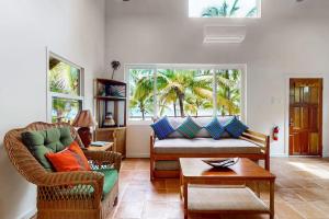 a living room with a couch and a table at Ocean Edge Gold Standard Certified in Maya Beach