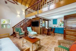 a living room filled with furniture and a staircase at Ocean Edge Gold Standard Certified in Maya Beach