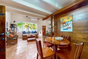 a living room with a table and chairs and a couch at Ocean Edge Gold Standard Certified in Maya Beach +48 photos
