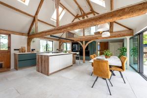 a kitchen with wooden ceilings and a table and chairs at 3 Bed in Ditchingham oc-s42751 in Ditchingham