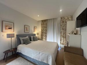 a bedroom with a bed and a television in it at RM MAISON by Rui & Mi in Tomar