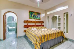 a bedroom with a bed in a room at Suite Junior at Midas Belize in San Ignacio