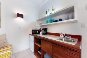 a kitchen with a sink and a counter top at Rainforest Suite at Casa DV Suites -Gold Standard Certified in Caye Caulker