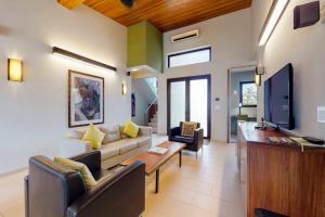 a living room with a couch and a table at Green Tower House in Placencia +32 photos