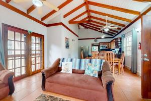 a living room with a couch and a dining room at Poseidon House in Riversdale