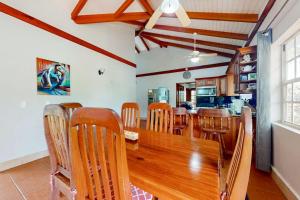a dining room with a wooden table and chairs at Poseidon House in Riversdale