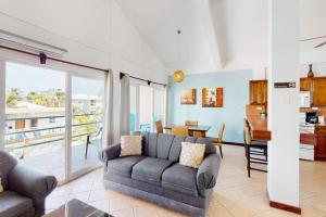 a living room with a couch and a table at Mara Laguna I301 in San Pedro