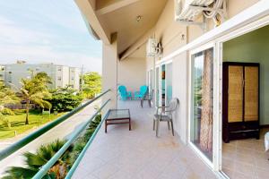 a balcony with chairs and tables on a building at Mara Laguna I301 in San Pedro