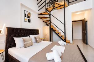 a bedroom with a bed in a room with a staircase at GLP Sivota in Syvota