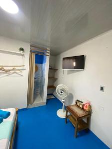 a room with a blue floor and a bed and a fan at Ramos de mar in Rincón