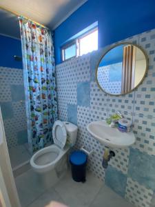 a bathroom with a toilet and a sink and a mirror at Ramos de mar in Rincón +17 photos