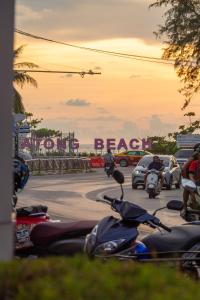 a group of motorcycles parked in a parking lot at Khaleej Mass Hotel Patong in Patong Beach