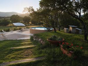 a garden with a pool and some flowers in a yard at I Mandorli in Lotzorai