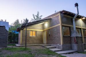 a small brick house with a street light on it at Potrerillos Nuestras Raíces in Potrerillos