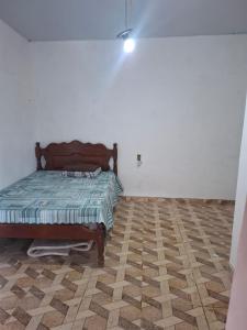 a bedroom with a bed in the corner of a room at Casa de Praia in Belém