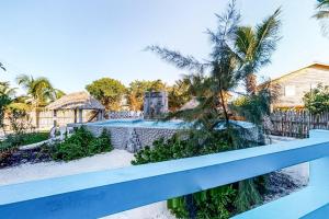 a view from the balcony of a house with a swimming pool at Affordable Suite with WiFi Partial AC Shared Rooftop Deck Pool and Grill in Caye Caulker