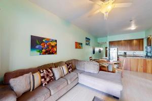 a living room with a couch and a kitchen at Relaxing condo with shared pool ocean views partial AC & WiFi in San Pedro +36 photos