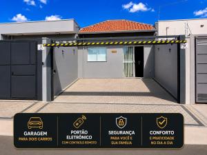 a property sign in front of a garage at Casa Lago da Dinda 3 in Espirito Santo Do Pinhal