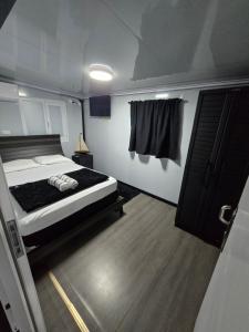a bedroom with a bed and a window at Villa Mi casita el paraiso costero in Aguada +85 photos