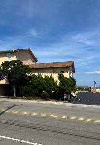 a building on the side of a road next to a street at Seven Seas in Kure Beach