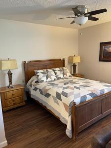 a bedroom with a bed and a ceiling fan at Highland Estates Condotel in Mesquite